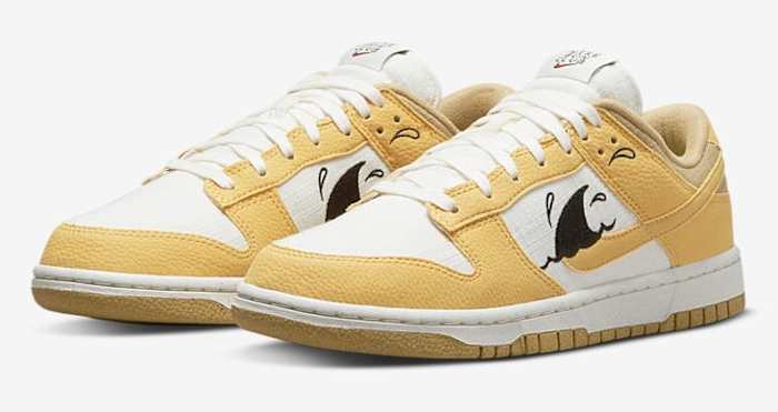 Gold and white Nike Dunk Low shoes.
